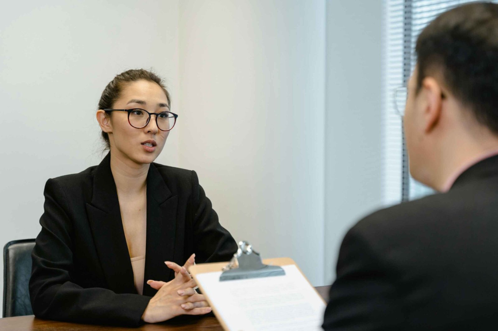 Woman in Business Attire Getting a Job Interview